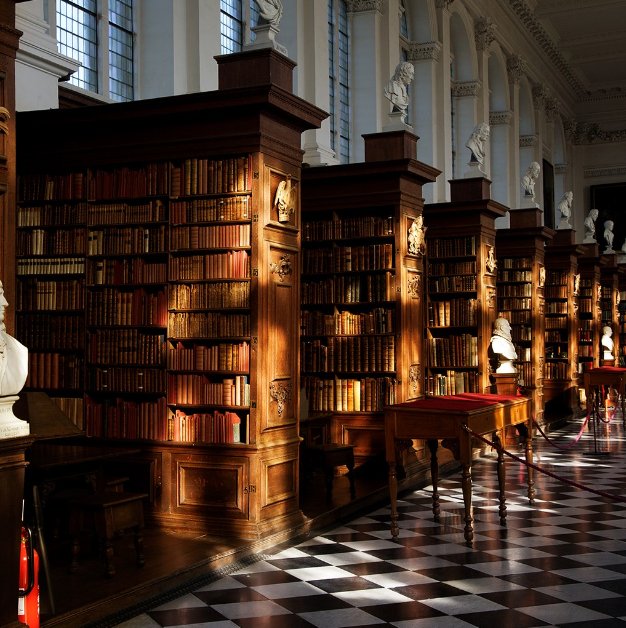 Interior of the Wren Library at Trinity College, Cambridge — reflecting the company’s University of Cambridge origins.